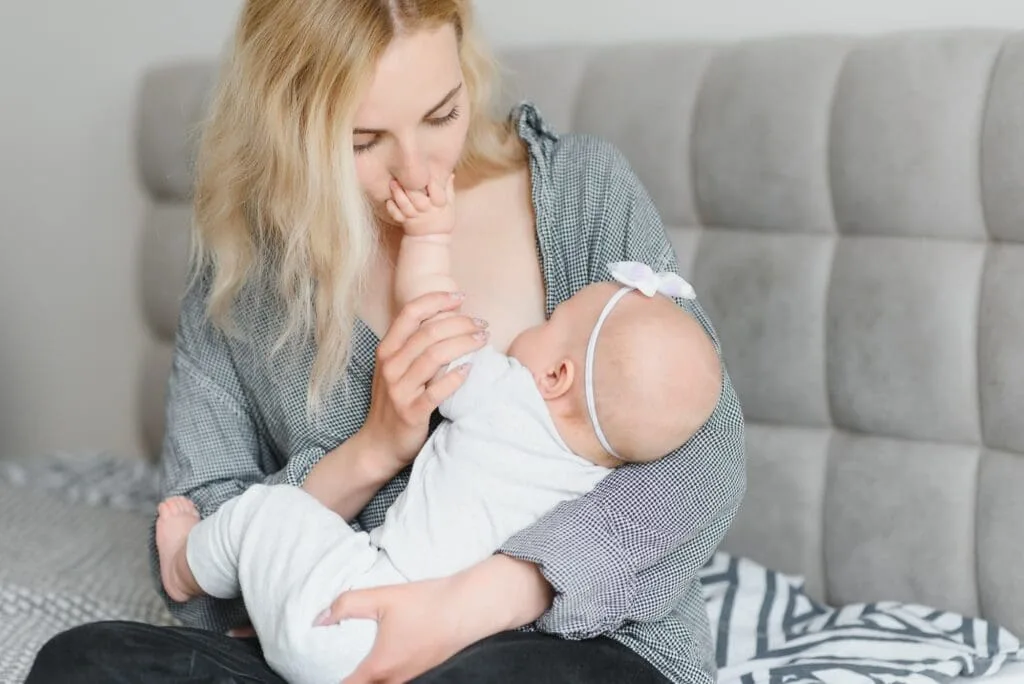 Mother breastfeeding her newborn during lactation support